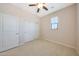 Bedroom featuring carpet, neutral walls, a ceiling fan, and sliding door closet at 20750 N 87Th St # 2062, Scottsdale, AZ 85255
