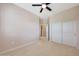 Neutral bedroom featuring a ceiling fan, plush carpet, and a closet with paneled doors at 20750 N 87Th St # 2062, Scottsdale, AZ 85255