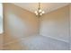 A dining room area featuring neutral walls, carpet, and a decorative wrought iron chandelier at 20750 N 87Th St # 2062, Scottsdale, AZ 85255