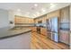 Well-lit kitchen with stainless steel appliances, wood cabinets, and hardwood floors at 20750 N 87Th St # 2062, Scottsdale, AZ 85255