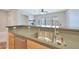 Kitchen island with sink and stainless steel dishwasher with a living area view at 20750 N 87Th St # 2062, Scottsdale, AZ 85255
