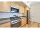 Kitchen with wood cabinets, stainless steel appliances, and hardwood floors at 20750 N 87Th St # 2062, Scottsdale, AZ 85255