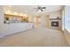 Open-concept living room with a fireplace, ceiling fan, and abundant natural light at 20750 N 87Th St # 2062, Scottsdale, AZ 85255