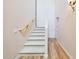 Carpeted staircase featuring a wooden handrail and wooden floors on the landing at 20750 N 87Th St # 2062, Scottsdale, AZ 85255