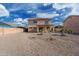 Expansive backyard, showcasing a home with a second story balcony and sliding glass doors at 22074 W Papago St, Buckeye, AZ 85326