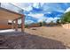 Large backyard with a gravel ground cover, a brick fence, covered patio and a balcony at 22074 W Papago St, Buckeye, AZ 85326