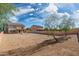 Large, low-maintenance backyard enclosed by a block wall fence with a tree at 22074 W Papago St, Buckeye, AZ 85326