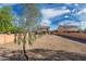 Large gravel backyard with ample space, featuring a view of the home and surrounding fence at 22074 W Papago St, Buckeye, AZ 85326