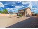 Spacious gravel backyard featuring a two-story home with a balcony and a small tree at 22074 W Papago St, Buckeye, AZ 85326