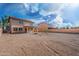 Open backyard space with a view of the house, balcony, and fire pit area at 22074 W Papago St, Buckeye, AZ 85326