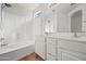 Bright bathroom with double vanity, tiled floor, and a shower-tub combination at 22074 W Papago St, Buckeye, AZ 85326