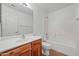 Bright bathroom with a modern vanity, tiled floor, and a shower-tub combination at 22074 W Papago St, Buckeye, AZ 85326