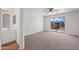 Bright bedroom with carpet, ceiling fan, and sliding door to a balcony with scenic views at 22074 W Papago St, Buckeye, AZ 85326