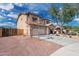 Exterior view of a two-story home with a spacious driveway and low-maintenance landscaping at 22074 W Papago St, Buckeye, AZ 85326