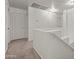 Bright upstairs hallway features neutral carpet, white walls, and access to rooms, and a staircase at 22074 W Papago St, Buckeye, AZ 85326