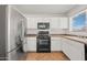 Modern kitchen featuring stainless steel appliances, and stylish tile flooring for easy maintenance at 22074 W Papago St, Buckeye, AZ 85326