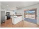 The kitchen features white cabinets, tile floors, stainless appliances, and sliding doors to the backyard at 22074 W Papago St, Buckeye, AZ 85326