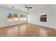 Spacious living room with tile flooring, ceiling fan, and multiple windows providing natural light at 22074 W Papago St, Buckeye, AZ 85326