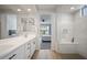 Bright bathroom showcases a subway tile shower, sleek vanity and tranquil bedroom view at 23018 E Mewes Rd, Queen Creek, AZ 85142