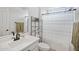 Fresh bathroom with white vanity, black fixtures, and a shower/tub with a patterned curtain at 23018 E Mewes Rd, Queen Creek, AZ 85142