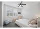 Bright bedroom with white walls, ceiling fan, and a plush bed with comfortable bedding and window shutters at 23018 E Mewes Rd, Queen Creek, AZ 85142