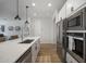 White modern kitchen with stainless steel appliances and large island at 23018 E Mewes Rd, Queen Creek, AZ 85142