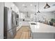 Kitchen features stainless steel appliances, white cabinets, and a large kitchen island at 23018 E Mewes Rd, Queen Creek, AZ 85142