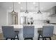 Modern kitchen with white cabinets, large island, and stainless steel appliances at 23018 E Mewes Rd, Queen Creek, AZ 85142