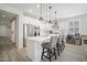 Bright, modern kitchen with white cabinetry, stainless steel appliances, and large center island at 23018 E Mewes Rd, Queen Creek, AZ 85142