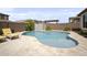 Backyard oasis featuring a sparkling pool and surrounding desert landscaping at 23018 E Mewes Rd, Queen Creek, AZ 85142