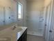 Bathroom with walk-in shower, single sink vanity, and tile floors at 24627 W Ripple Rd, Buckeye, AZ 85326