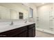 Bathroom features double sinks, a large mirror, and a walk-in shower at 24627 W Ripple Rd, Buckeye, AZ 85326
