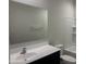 The bathroom features a large mirror, a vanity with sink, toilet, and a shower/tub combo with white tile surround at 24627 W Ripple Rd, Buckeye, AZ 85326