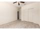 This bedroom features neutral carpet, a ceiling fan and built-in closet with light-colored walls at 24627 W Ripple Rd, Buckeye, AZ 85326