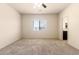 Bright bedroom with carpet, ceiling fan and view into the bathroom at 24627 W Ripple Rd, Buckeye, AZ 85326