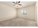 Spacious bedroom with carpet flooring and a window providing natural light at 24627 W Ripple Rd, Buckeye, AZ 85326