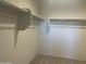 Walk-in closet with built-in shelving and neutral carpet at 24627 W Ripple Rd, Buckeye, AZ 85326