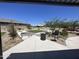 This community area features green lawns, mature trees and plantings, and a cornhole game and BBQ grill at 24627 W Ripple Rd, Buckeye, AZ 85326