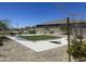This community area features green lawns, mature trees and plantings, and a cornhole game at 24627 W Ripple Rd, Buckeye, AZ 85326