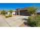 Inviting single-story home with a well-maintained front yard and two-car garage at 24627 W Ripple Rd, Buckeye, AZ 85326