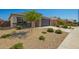 Beautiful single-story home with desert landscaping, manicured bushes and a two-car garage at 24627 W Ripple Rd, Buckeye, AZ 85326