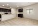 Bright kitchen features tile flooring, ample cabinet space, and a breakfast bar at 24627 W Ripple Rd, Buckeye, AZ 85326