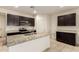 Modern kitchen featuring dark cabinets, granite countertops, and stainless steel appliances at 24627 W Ripple Rd, Buckeye, AZ 85326