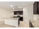 Modern kitchen featuring dark wood cabinets and a large granite island at 24627 W Ripple Rd, Buckeye, AZ 85326