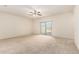 Spacious living room with neutral carpet and sliding glass doors to a patio space at 24627 W Ripple Rd, Buckeye, AZ 85326