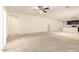 Bright living room with carpeted floors that leads into the adjacent kitchen at 24627 W Ripple Rd, Buckeye, AZ 85326