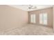 This bedroom features natural light from shuttered windows, on neutral carpeting at 24907 S Lakestar Dr, Sun Lakes, AZ 85248