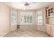 Bright breakfast nook featuring tile flooring, shuttered windows, and a ceiling fan at 24907 S Lakestar Dr, Sun Lakes, AZ 85248
