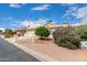 Landscaped front yard with a desert landscape, mature trees, and a beige single-story home at 24907 S Lakestar Dr, Sun Lakes, AZ 85248