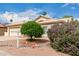 Beige home featuring manicured landscaping, mature trees, and a well-maintained front yard at 24907 S Lakestar Dr, Sun Lakes, AZ 85248